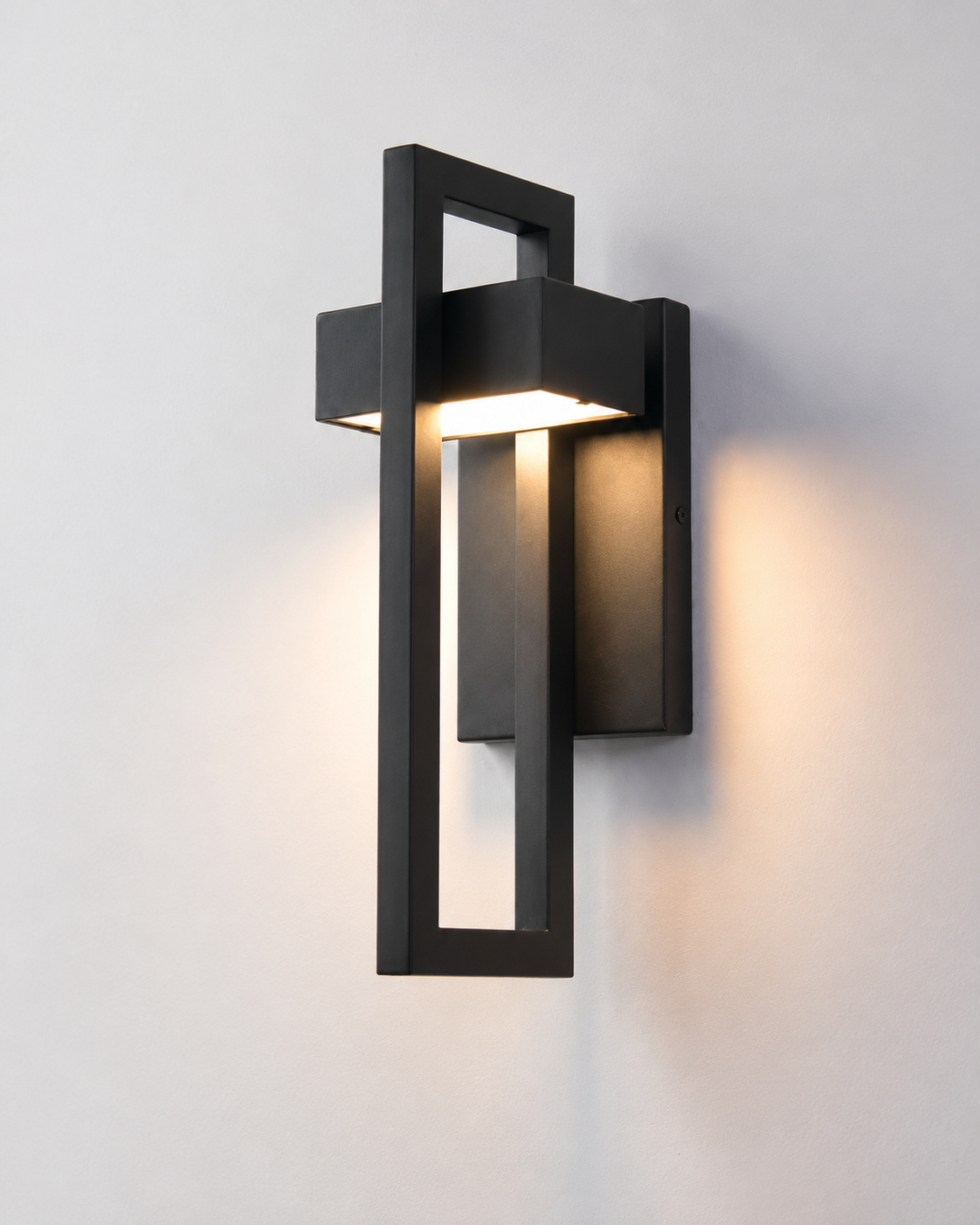 Modern black geometric wall sconce with warm ambient lighting for contemporary interiors