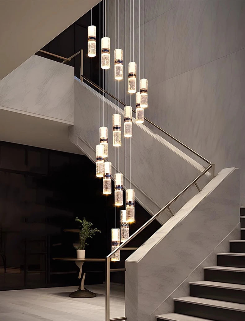 Modern crystal pendant lights illuminating a marble staircase in a luxury interior