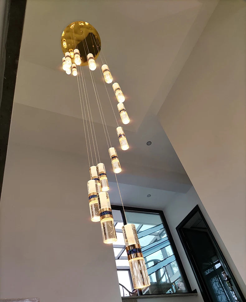 Modern cascading pendant light with gold accents and crystal cylinders for contemporary interiors