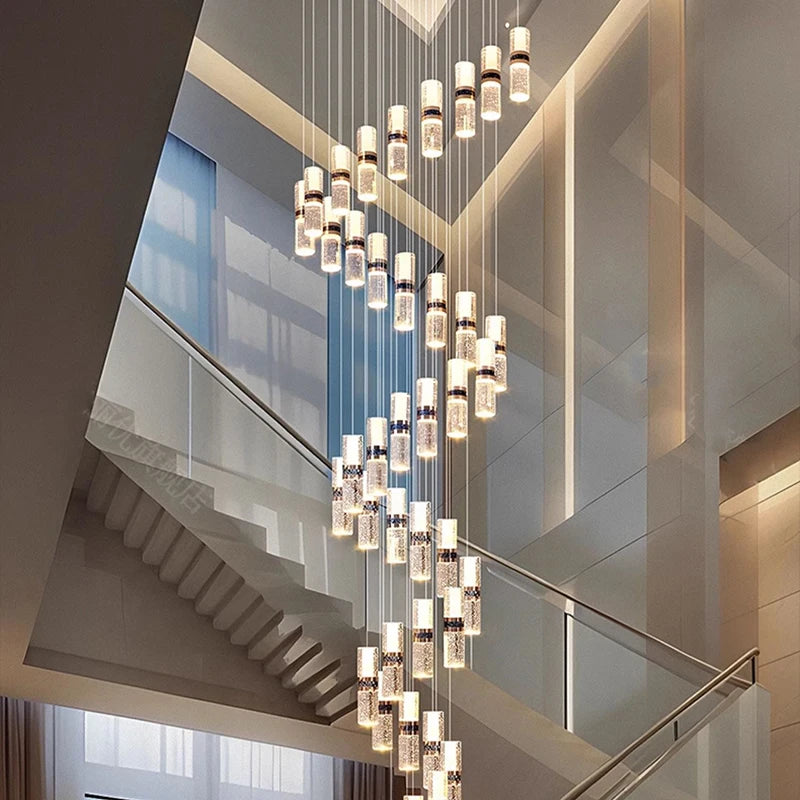 Modern spiral chandelier with crystal accents illuminating a contemporary staircase interior