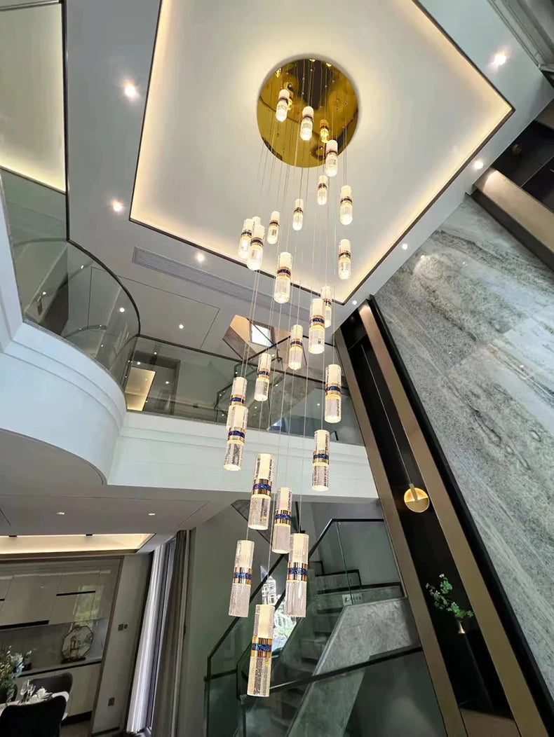 Modern crystal pendant chandelier with gold accents in luxury home foyer