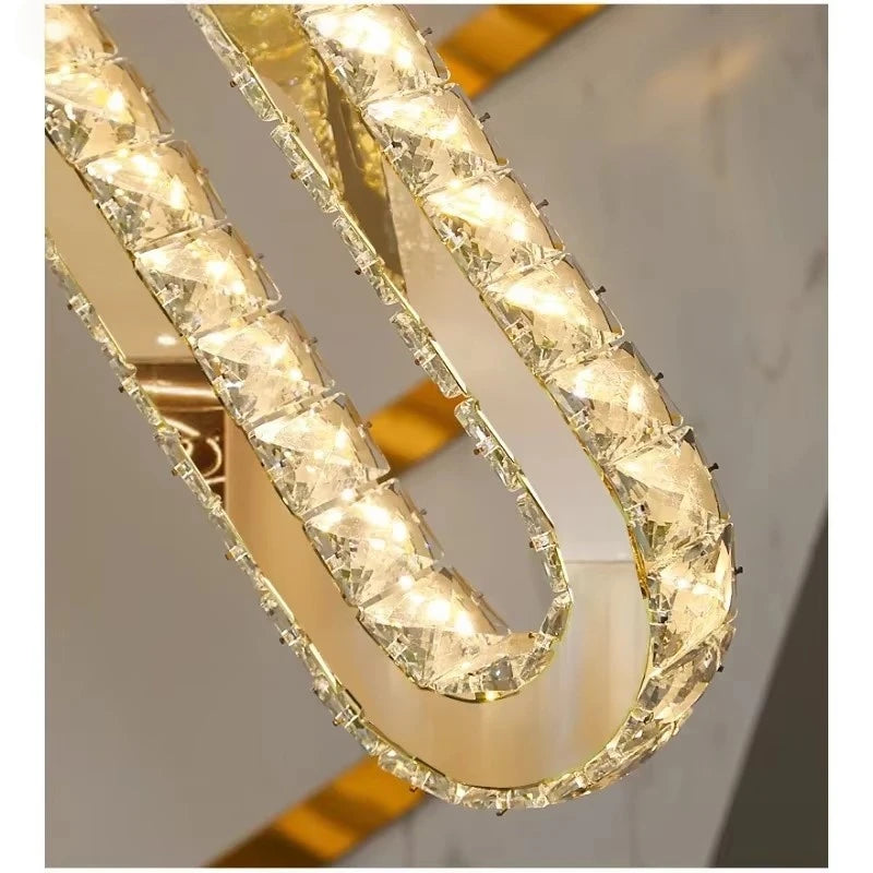 Modern crystal chandelier with gold frame and warm LED lights for luxury interior lighting