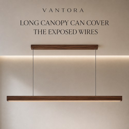 A modern linear pendant light with a dark wood finish and integrated warm white LED lighting, suspended by thin cables. The image includes text overlays reading 'VANTORA' and 'LONG CANOPY CAN COVER THE EXPOSED WIRES' against a neutral beige wall.