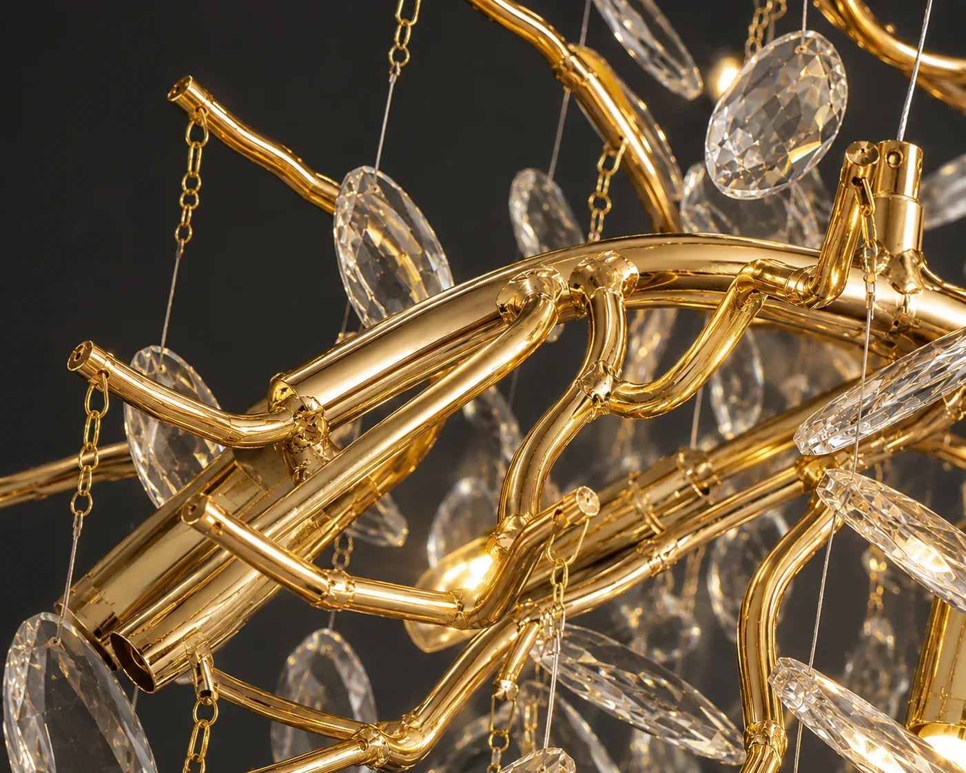 Gold chandelier with crystal elements against a dark background