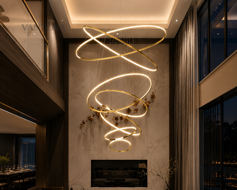 Modern spiral pendant light with gold rings illuminating luxury living room with marble wall and fireplace