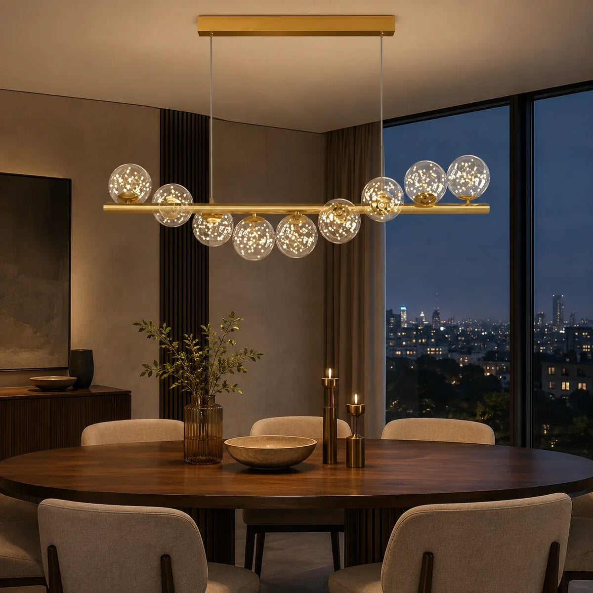 Lyra Linear Chandelier hanging over a modern dining table with warm glass globe lighting
