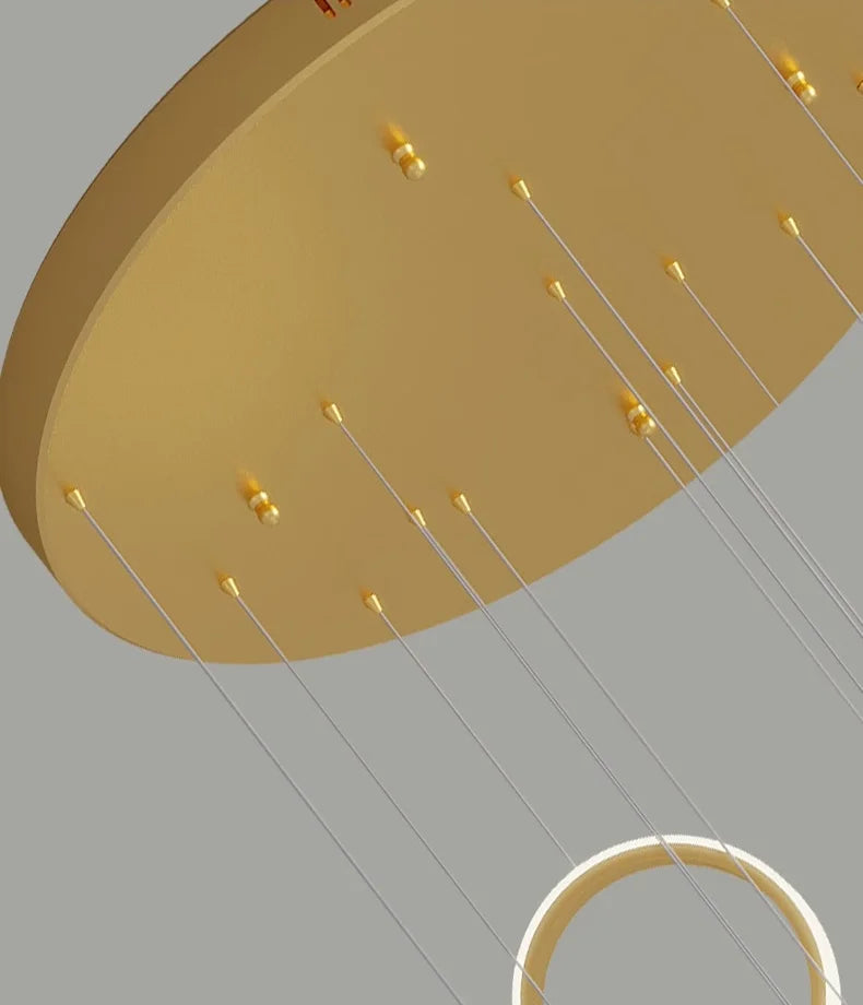 Gold pendant light fixture on a gray background