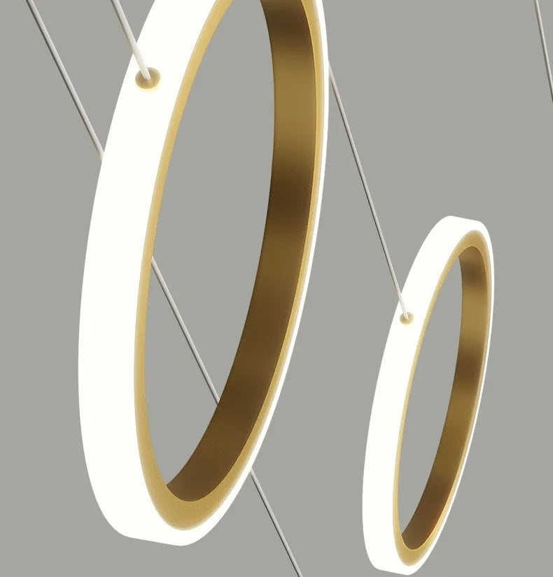 Gold hoop earrings on a gray background