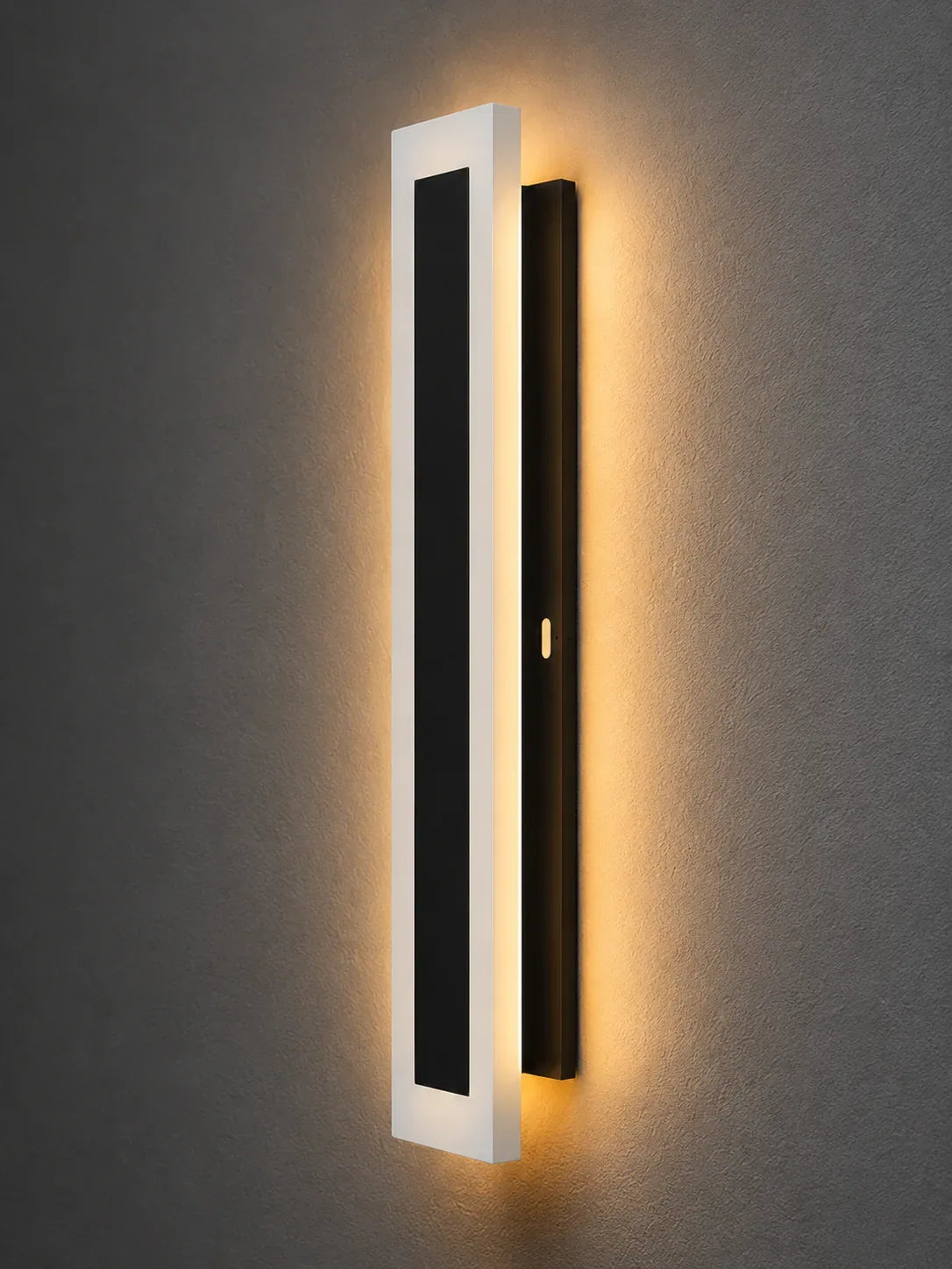 Modern wall sconce with black and white design on a gray wall