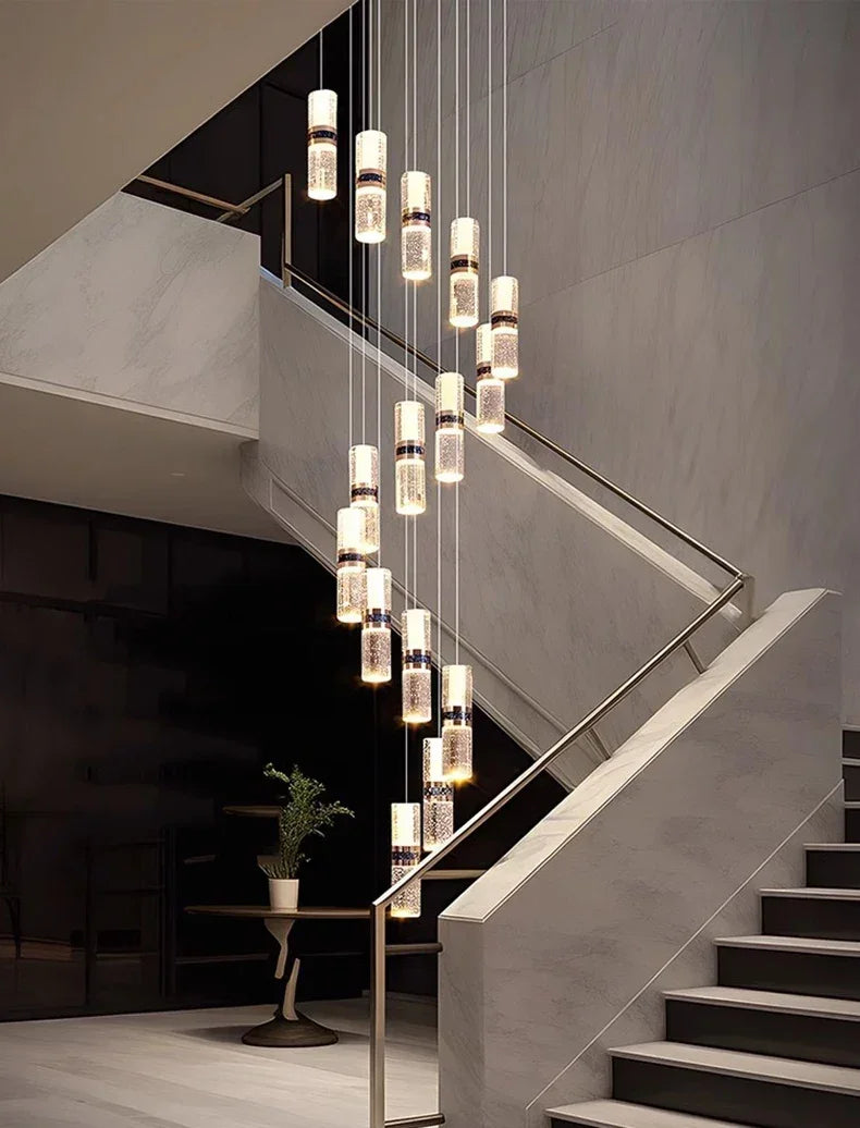 Modern crystal pendant lights illuminating a marble staircase in a luxury interior