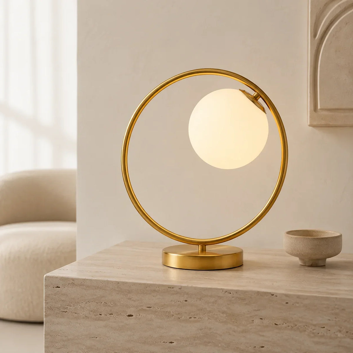 Close-up detail of Soren Table Lamp's brass frame and frosted glass globe