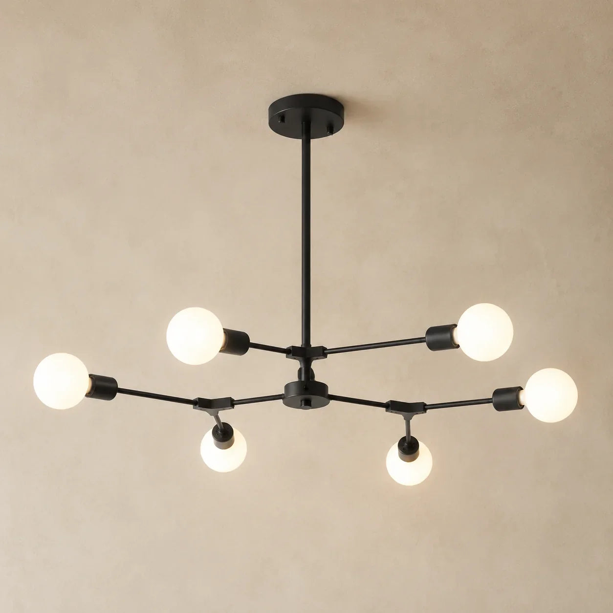 Close-up detail of Vega Branch Chandelier's angular gold arms and light fixtures